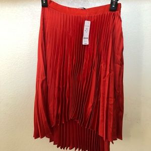 Bebe red pleated high low skirt. NWT